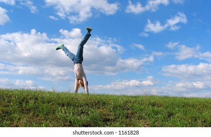 Cartwheel On Grass On The Sky & Clouds Background