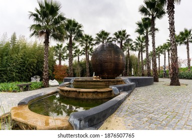 Carvalhal Bombarral, Portugal - 13 December 2020: sculpture fountain and palm gardens in the Buddha Eden Garden in Portugal