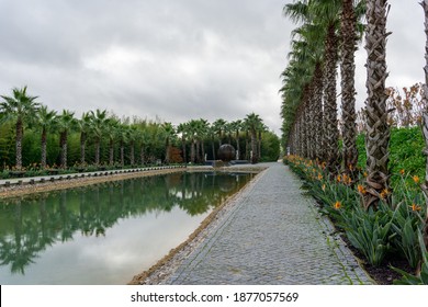 Carvalhal Bombarral, Portugal - 13 December 2020: meditation lake and palm trees in the Buddha Eden gardens in Portugal
