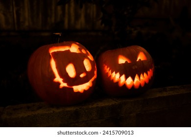 Carved haloween pumpkins of hello kitty and a grinning face