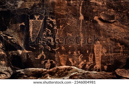 A carved petroglyph rock art panel of anthropomorphic spirit figures in Sevenmile canyon, located near Canyonlands National Park in southern central Utah, United States. 