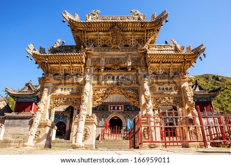 Carved stone torii in front of the Longquan temple door. The Longquan temple is one of Mount Wutai Temples. The Mount Wutai is one of famous Buddhist holy land and tourism destination in China