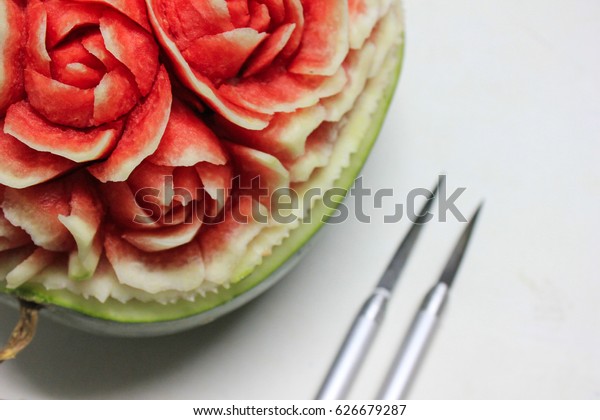Carved watermelon rose\
and carving knife