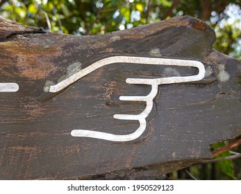 Carved Wood Sign Of White Hand With Index Finger Pointing To The Right.