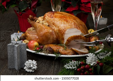 Carving garnished roasted Christmas turkey with grab apples, sweet chestnut, cranberry, Christmas ornaments, candles, and pine cones. - Powered by Shutterstock