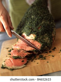 Carving a leg of lamb with herbs