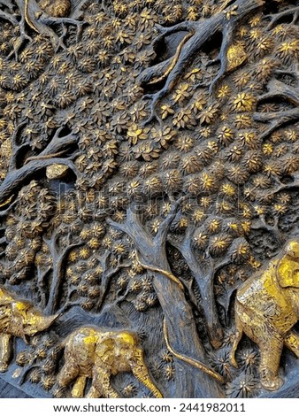The carvings of elephants and trees are detailed and beautiful. It's an old thing.