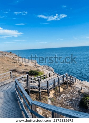 Carvoeiro boardwalk over the Algarve cliffs in Portugal. Copy space