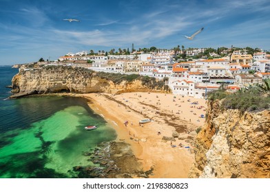 Carvoeiro fishing village with beautiful beach in Algarve, Portugal. View of beach in Carvoeiro town with colorful houses on coast of Portugal. Praia de Carvoeiro in Algarve