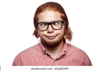 Carzy funny cross eyed bearded readhead businessman with red shirt and freckles and glasses looking at camera. studio shot isolated on white.