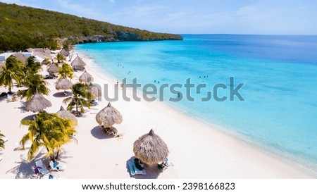 Cas Abao Beach Playa Cas Abao Curacao Caribbean island of Curacao, Playa Cas Abao with beach chairs and umbrellas in Curacao and a turqouse colored ocean Imagine de stoc © 