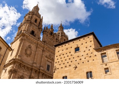 Casa de las Conchas and La Clerecía church buildings in Salamanca, Spain, low angle view. - Powered by Shutterstock