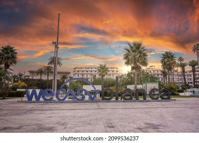 Casablanca, Morocco. October 10, 2021. Name of city "we casablanca" in large letters on ground against buildings during sunset