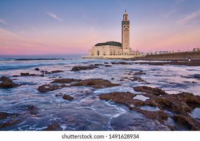 Casablanca sunset panorama with Hassan II Mosque II and waves of  Atlantic Ocean, Morocco.