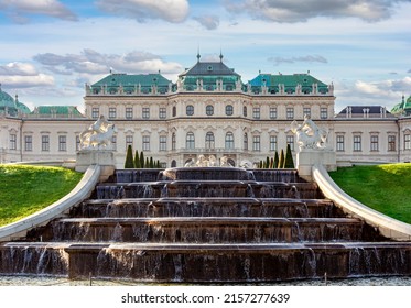 Cascade fountain with ancient sculptures and Upper Belvedere palace in Vienna, Austria