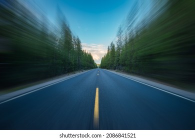 Cascade Lakes Highway Oregon Diminishing Perspective. Empty Lane Highway Through Forest. Selective Blur