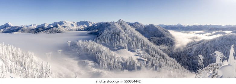 Cascade Mountain Range Panorama with Ice Cold Winter Snow and Hazy Blue Sky