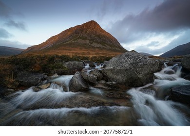 Cascade Waterfall With The Devils Point Mountain Located In The Cairngorms, Highlands Scotland.