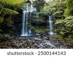 Cascades of Russell Falls, Tasmania, Australia. Beautiful, pristine waterfall in southern Tasmania. Water flows in multiple streams forming a stunning waterfall. Lush and wild nature of Tasmania. 