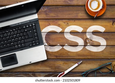 Cascading Style Sheets. Word CSS on wooden desk and laptop 