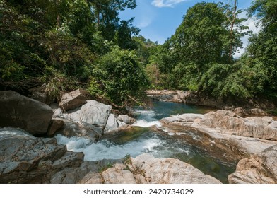 Cascading waterfall and landscape with a mountain stream in the rainforest. Serene natural scenery with lush greenery, flowing water, and a tranquil atmosphere. - Powered by Shutterstock