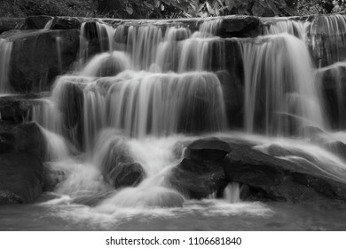 Cascading waterfall in rainy season deep inside the tropical forest of Thailand in black and white color - Powered by Shutterstock