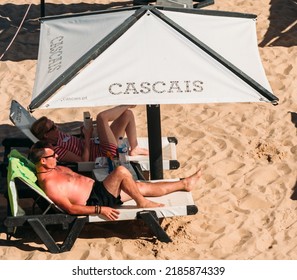 Cascais, Portugal - August 2, 2022: Sunburnt Man Relaxed At Conceicao Beach In Cascais Near Lisbon, Portugal During The Summer