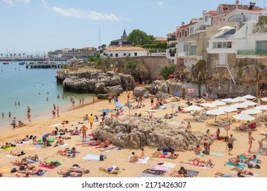 Cascais, Portugal - June 22, 2018: Cascais near Lisbon, seaside town. Panoramic view with port and beach, filled with resting people in a summer sunny day.