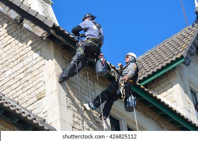 CASCAIS, PORTUGAL - MARCH 08, 2016: Abseiling Building Maintenance Workers At Work.