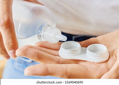 Case For Contact Lenses And Bottle With Solution In Woman Hands. Eyewear, Eyesight And Vision, Eye Care And Health, Ophthalmology And Optometry Concept, Selective Focus, Close Up