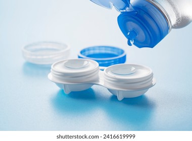 Case of contact lenses placed on a blue background. Pouring the  - Powered by Shutterstock