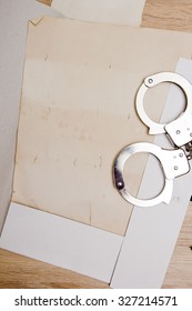 The Case File, With Handcuffs In An Open Folder.