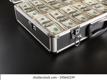 Case full of money on gray background