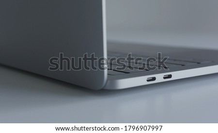 Case of open thin laptop. Action. Close-up details of beautiful modern laptop with thin body. Modern laptop with minimalistic and stylish design of case