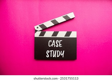 Case study message written on clapperboard with pink background. Conceptual case study symbol. Copy space.