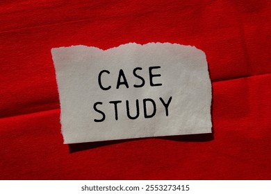 Case study message written on ripped torn paper piece on red background. Conceptual case study symbol. Copy space.