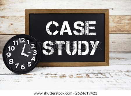 Case Study text message and alarm clock on wooden background