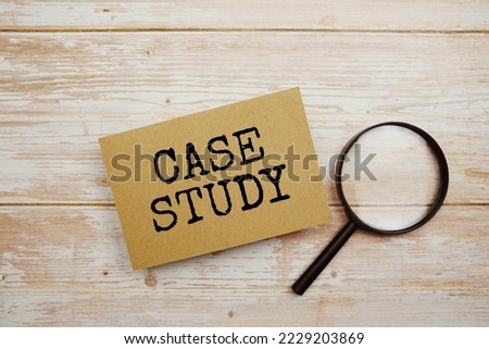 Case Study text message and magnifying glass with space copy on wooden background