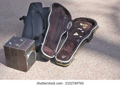 Case for violin. Amplifier. Street musician. Violin case for street musician with coins.