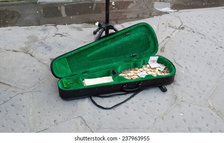 The case of the violin busker with banknotes and coins.