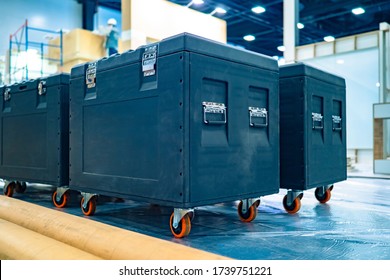 Cases for musical equipment. Sound equipment is packed in protective boxes. Boxes for transporting concert equipment. Concept - rental of concert furnishing. Concert preparation in the background