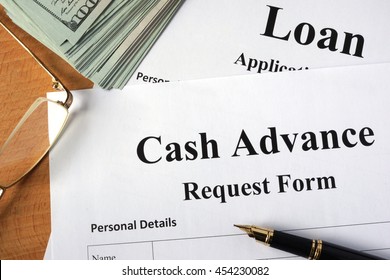 Cash Advance Form On A Wooden Table.