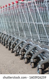 Cash And Carry Trolleys Standing In A Row. Close-up. Vertical Photo