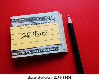Cash dollars money and pencil writing on yellow note SIDE HUSTLE, concept of make more income from side gig or second job along side full time employment - Shutterstock ID 2176491401