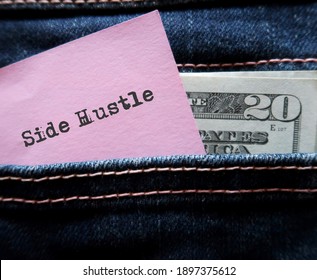 Cash dollars money and pink note with hand written text SIDE HUSTLE in jeans pocket , concept of young generation make more income from side job or side hustle in gig economy