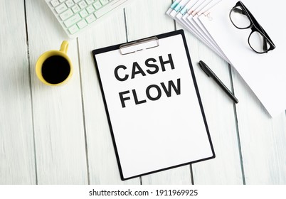 Cash flow business finance conceptual - handwriting on notepad with cup of coffee and calculator - Shutterstock ID 1911969925
