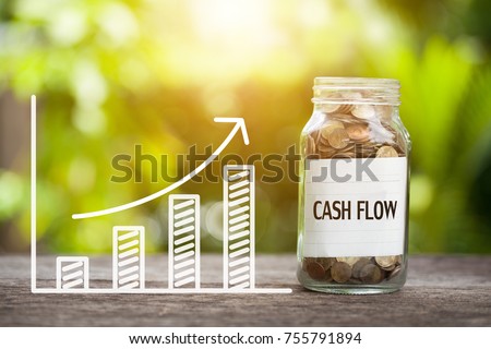 Cash Flow Word With Coin In Glass Jar and graph up. Financial Concept