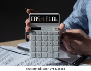 Cash Flow Word On White Calculator In Male Hands. Cashflow Statement In Accountant Arm.