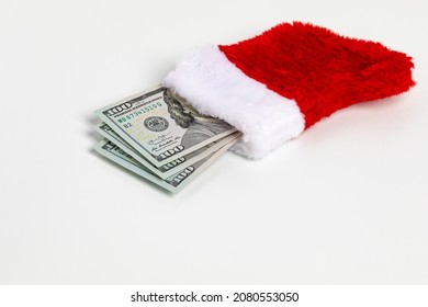 Cash Gift Of 100 Dollar Bills In Christmas Stocking. Gift Tax, Charitable Donation And Holiday Present Concept