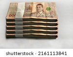 Cash of hundred baht bills, Many hundred baht bills on white table background texture. bundles of money scattered on the office desk. wealth and imcome concept